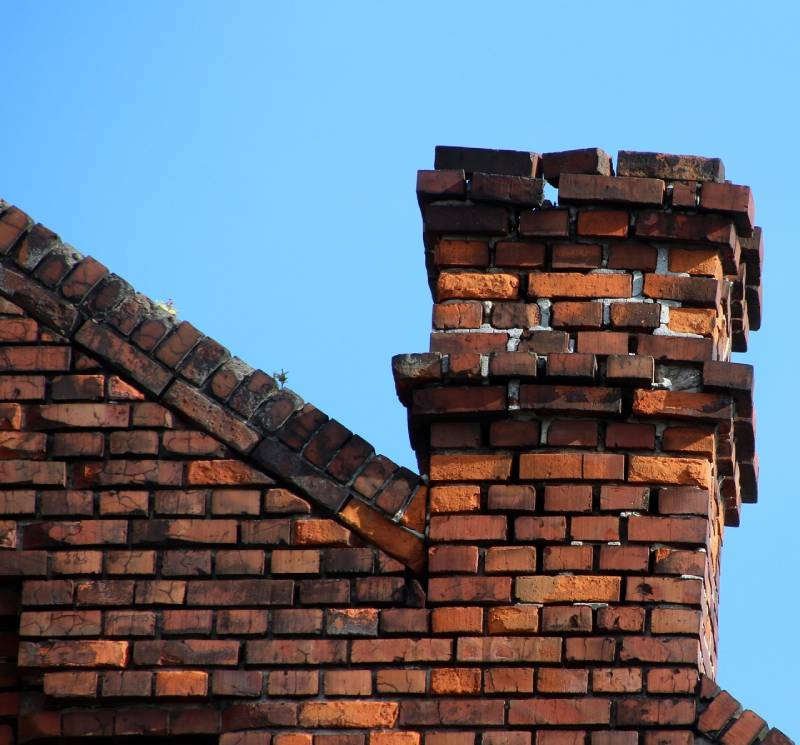 Signs Your Sutton Home Needs a Chimney Inspection Damaged chimney on an Sutton home showing cracks and missing mortar